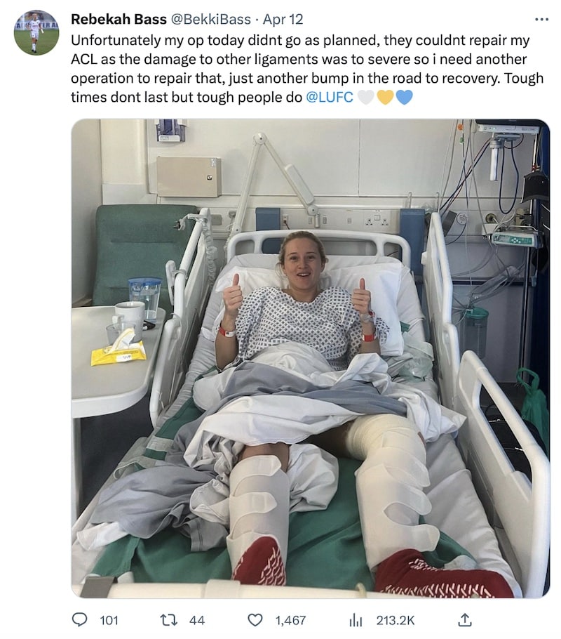 A tweet from Rebekah Bass about her knee op not working out, but she's still giving double thumbs up from her hospital bed because she is magnificent