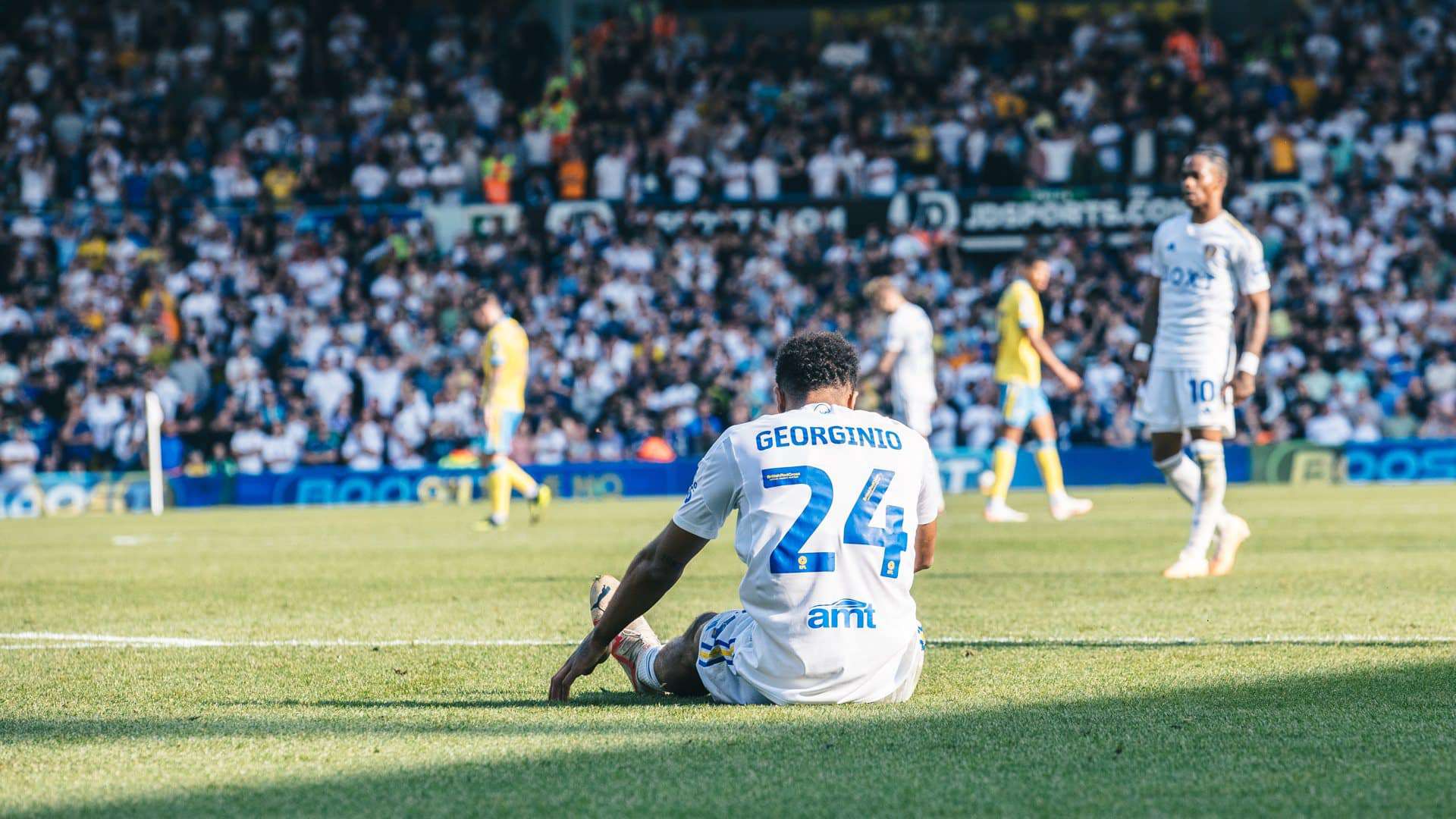 A photo of Georginio Rutter's back. He's sitting on the ground and you can tell by his hunched shoulders this is just after he missed a sitter