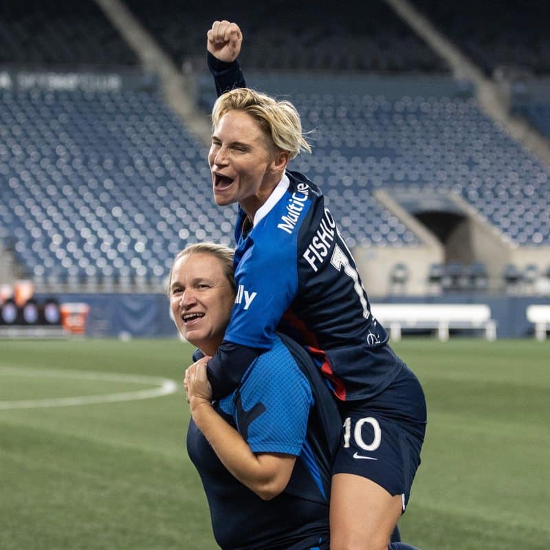 Inescapable Jess Fishlock and Laura Harvey celebrating together at OL Reign, Fishlock is up on Harvey's shoulders punching the air