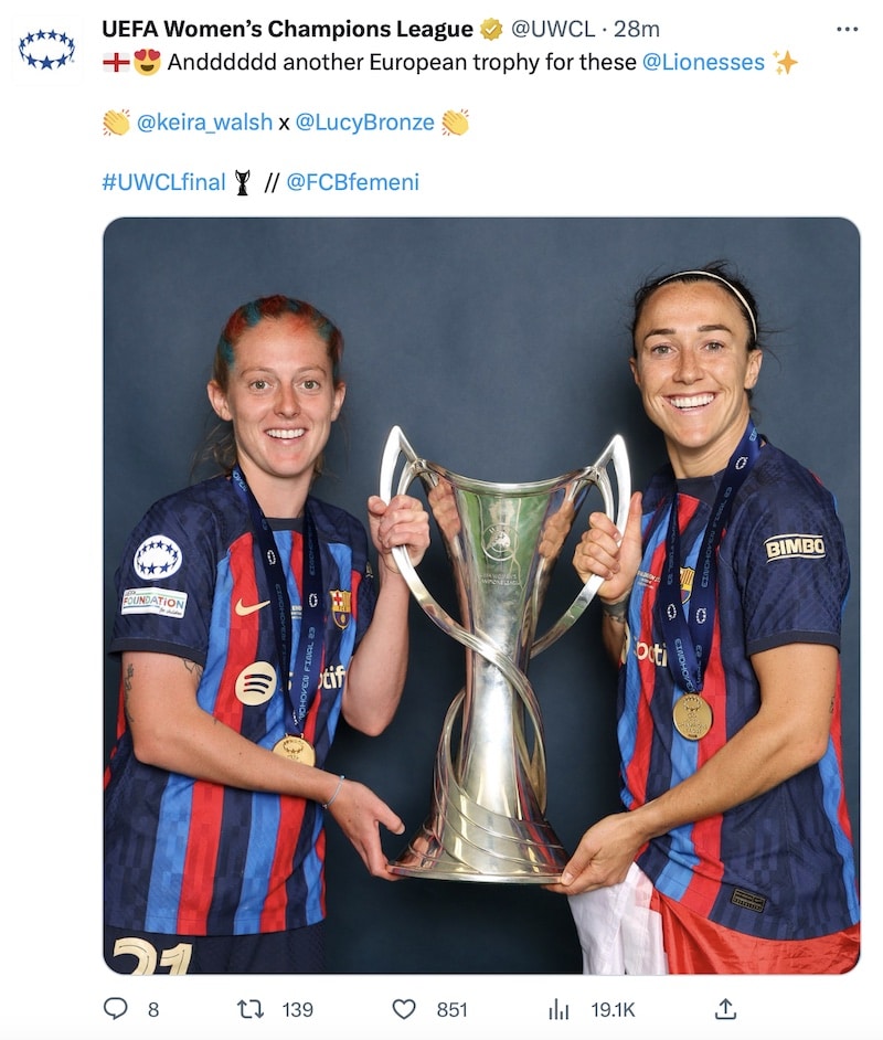Lucy Bronze and Keira Walsh pose with the Champions League trophy