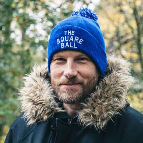 Simon Rix of Kaiser Chiefs wearing a TSB 1970s logo pom beanie in royal blue