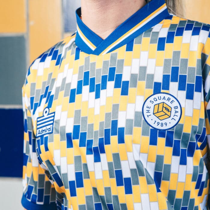 A close up of The Square Ball x Admiral 2023/24 Lowfields shirt, featuring a blue, yellow and white tiled pattern to replicate the walls of the Lowfields tunnel