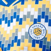 A close up of The Square Ball x Admiral 2023/24 Lowfields shirt, featuring a blue, yellow and white tiled pattern to replicate the walls of the Lowfields tunnel