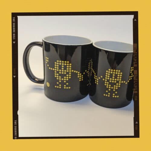 A photo of our black scoreboard 'pixelmen' mugs