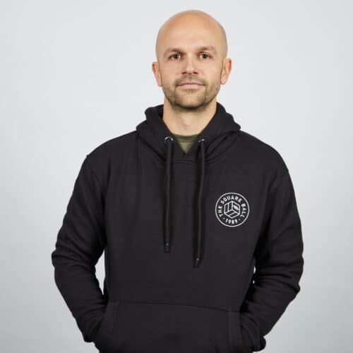 Our Michael wearing a TSB pocket logo heavyweight hoodie in black