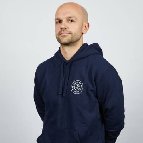 Our Michael wearing a TSB pocket logo hoodie in navy