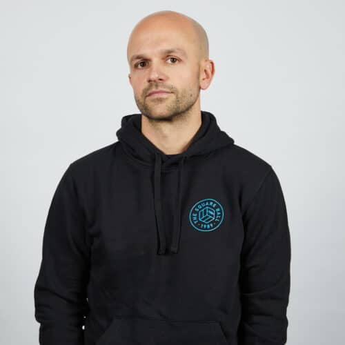 Our Michael wearing a black TSB WAFLL hoodie with the pocket logo in blue