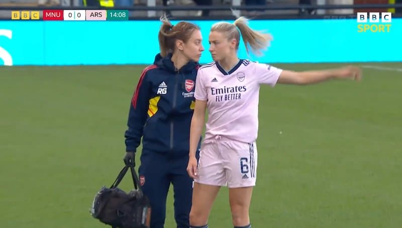 Leah Williamson is walking sternly off the pitch