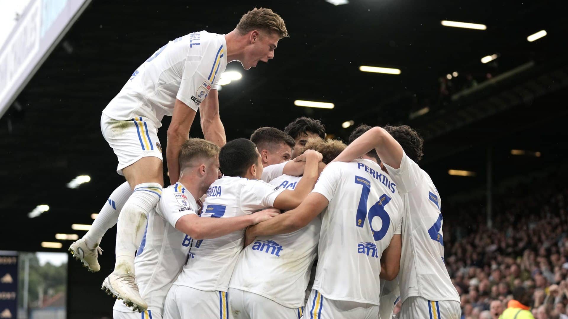 United's players are in a huddle celebrating the equaliser against Cardiff, unaware that one huge Charlie Cresswell is leaping over and into them with a single bound