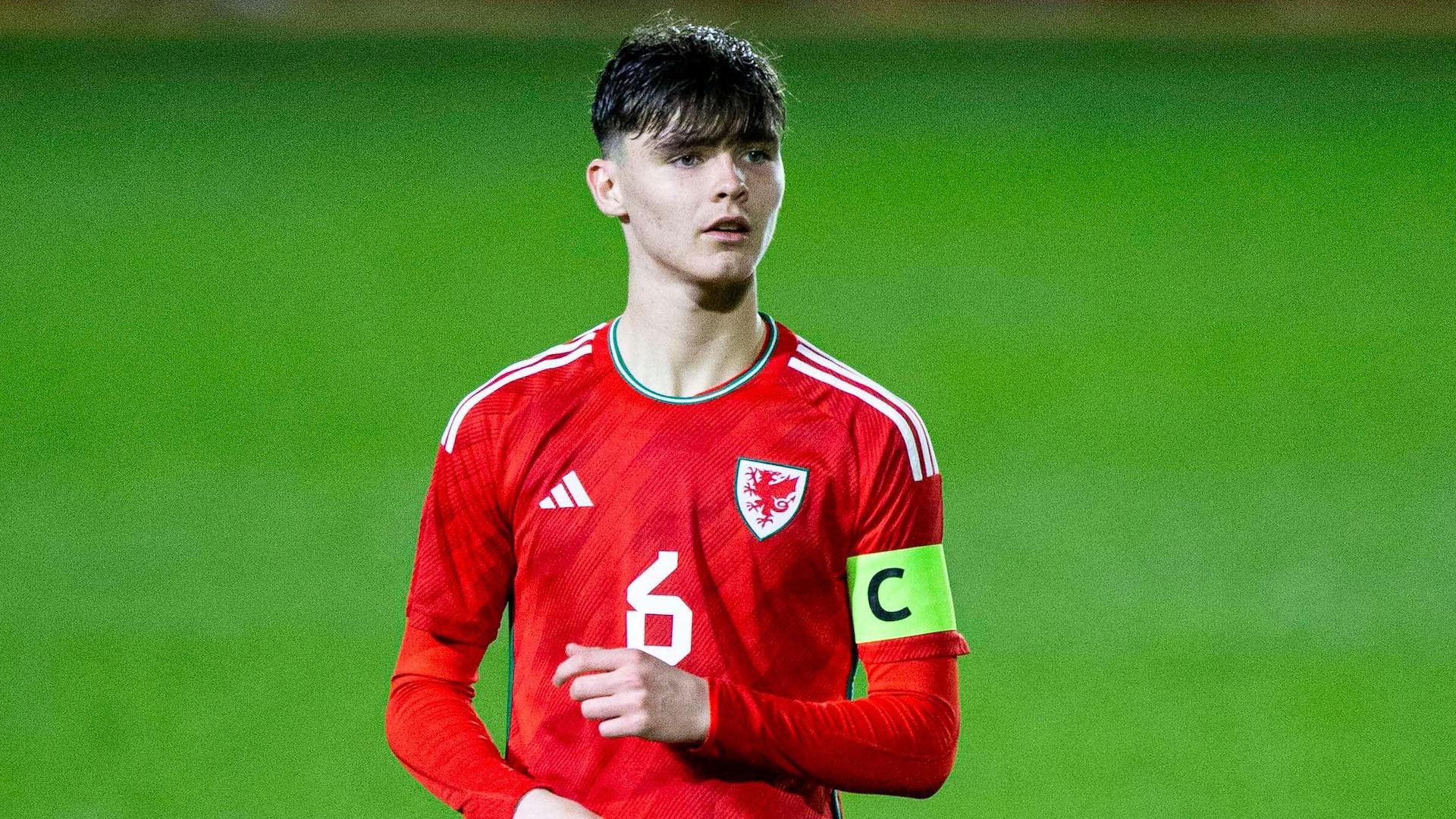 Leeds U21s midfielder Charlie Crew playing for Wales U17s and wearing the captain's armband. He's got a big sweepy fringe 'cos he's young