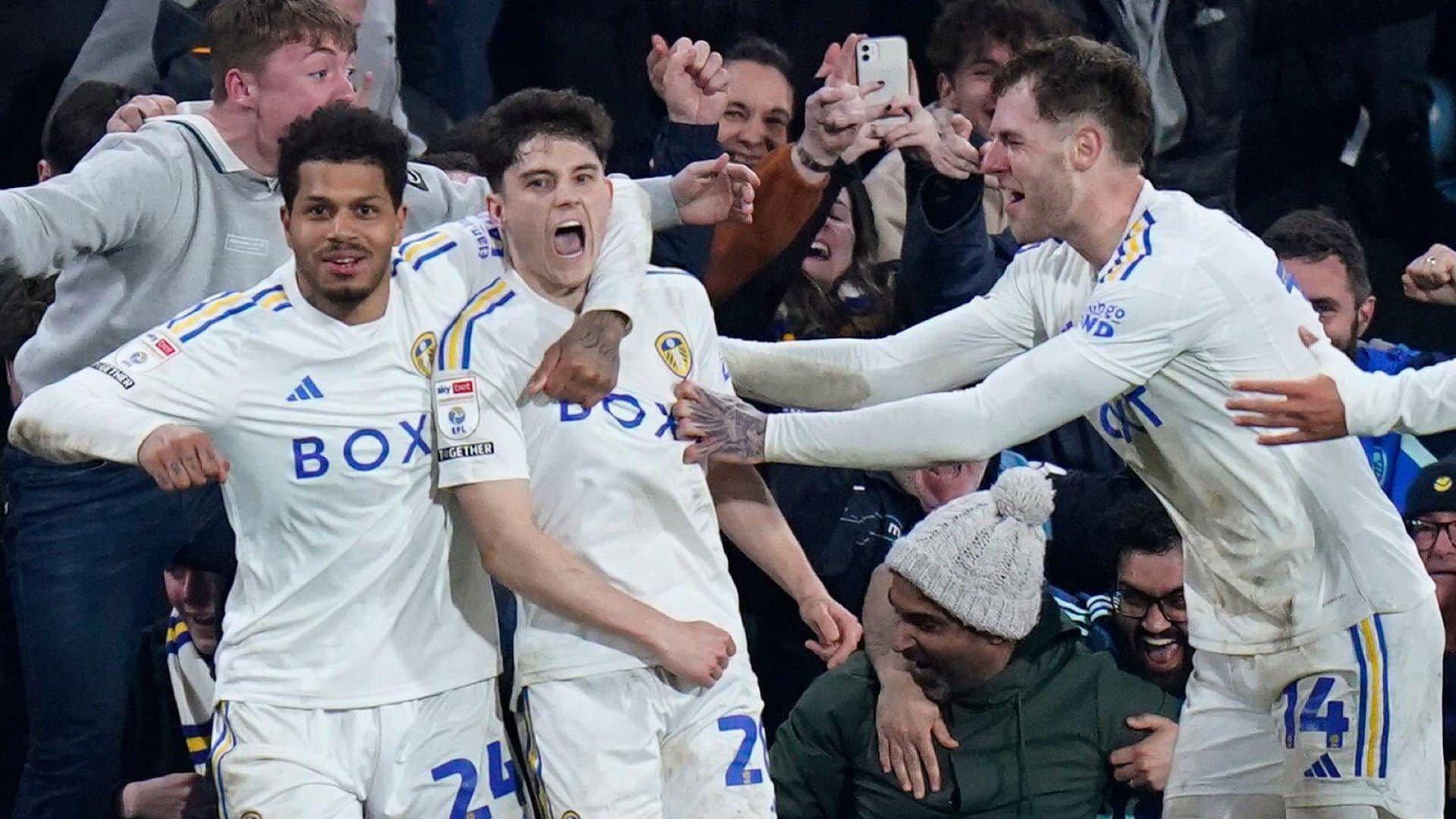 Dan James looks stunned and Georginio Rutter looks down the camera, as Rodon appears from miles away to celebrate Leeds' third goal against Hull