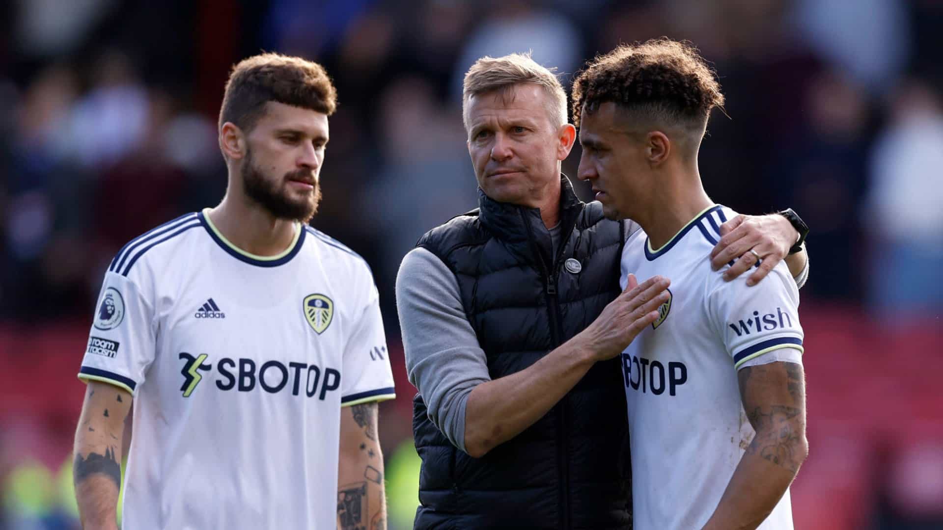 A photo of Jesse Marsch consolong Rodrigo while Mateusz Klich looks disappointed in the background