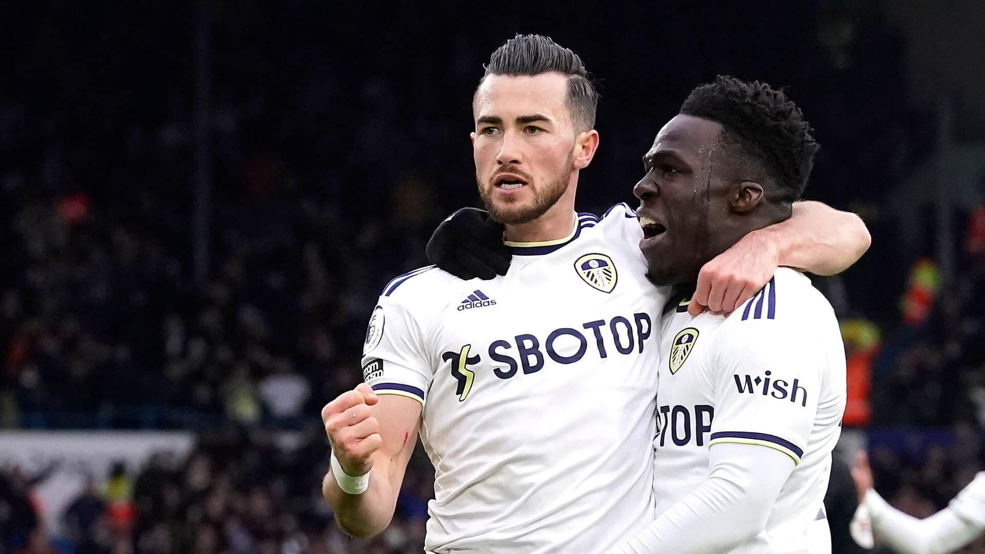 Jackie Harrison celebrating his goal against Brighton, looking like a press cutting from the 1950s, with Wilf Gnonto, who looks ready to bite his ear off