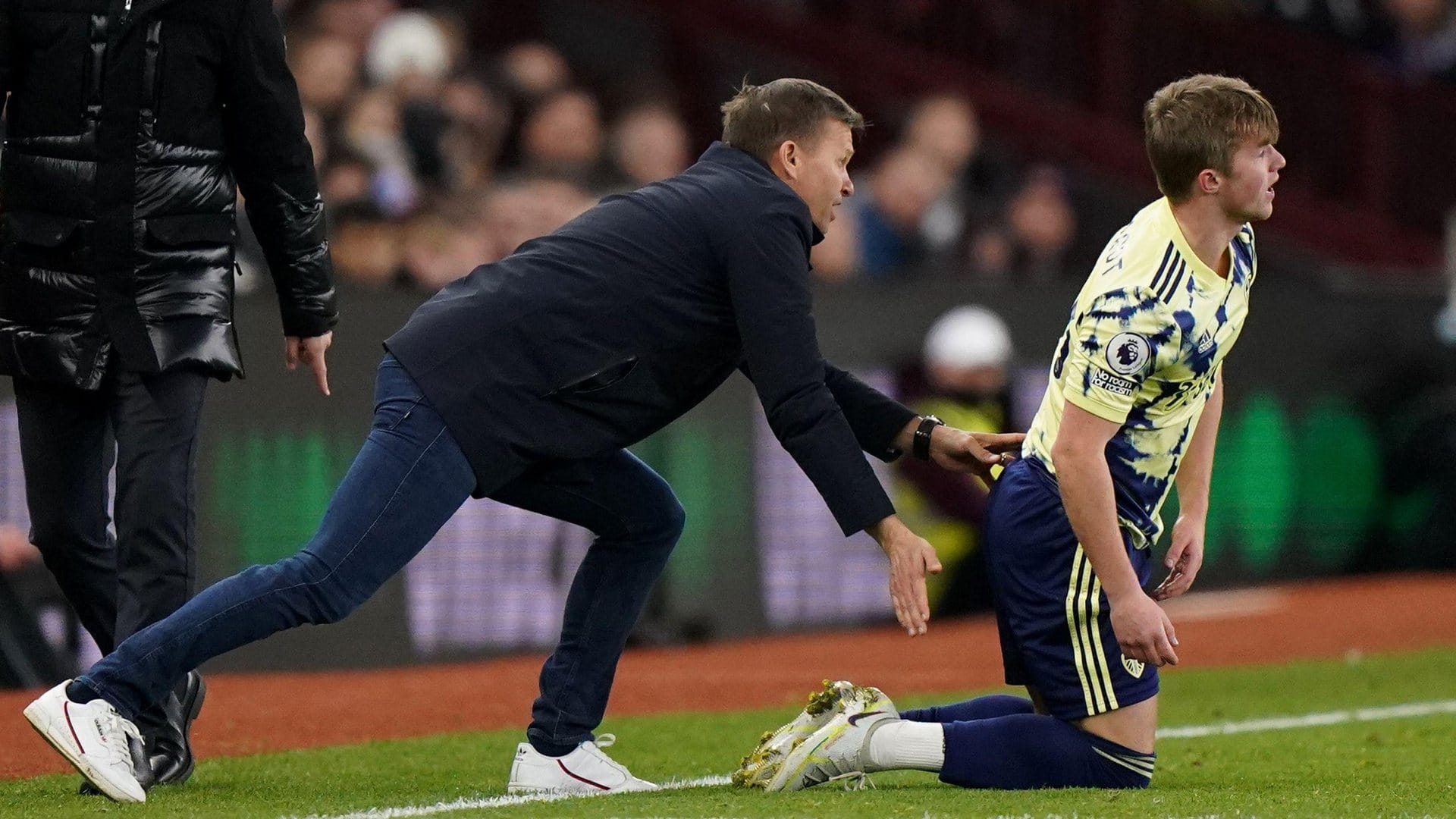 With Joffy Gelhardt down on his knees near the touchline in Leeds' game against Aston Villa, Jesse Marsch is leaning in from behind him with the encouraging butt-pat Joffy no doubt wanted