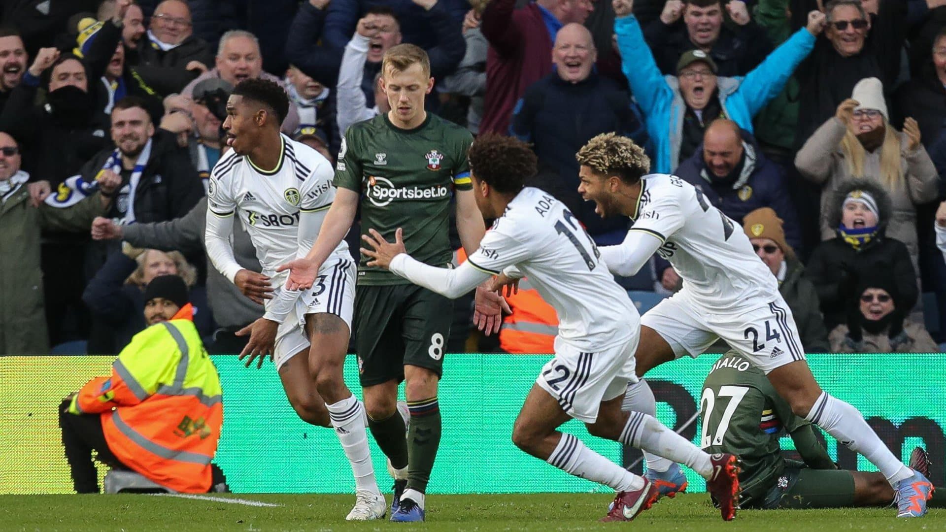 Junior Firpo sets off to celebrate his goal, while Southampton's James Ward-Prowse looks all miserable like 'boo hoo, why won't they let me score a free-kick, wah'