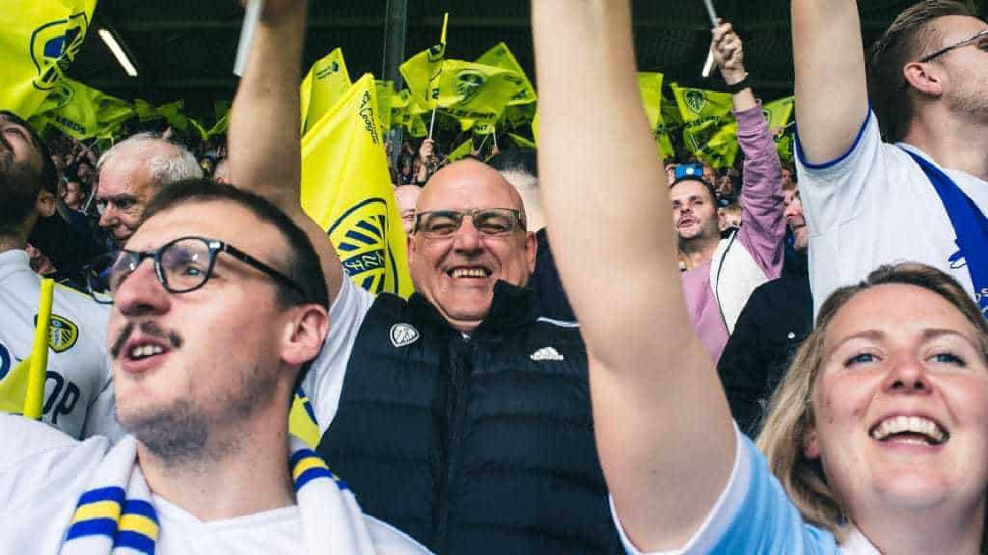 Leeds fans waving flags on the Kop against Everton. The one bloke in the middle of this shot is loving it, they all are!