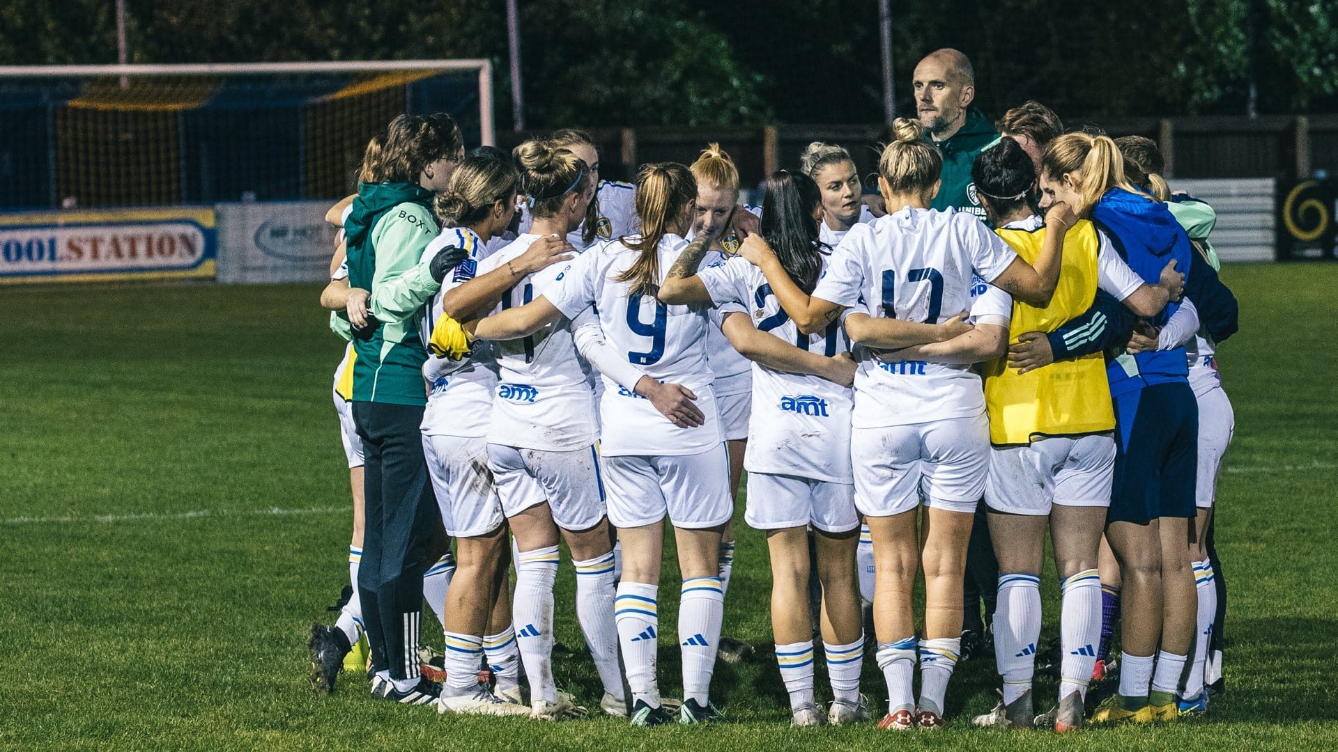 Leeds United Women players and staff form a huddle before their game against FCUM