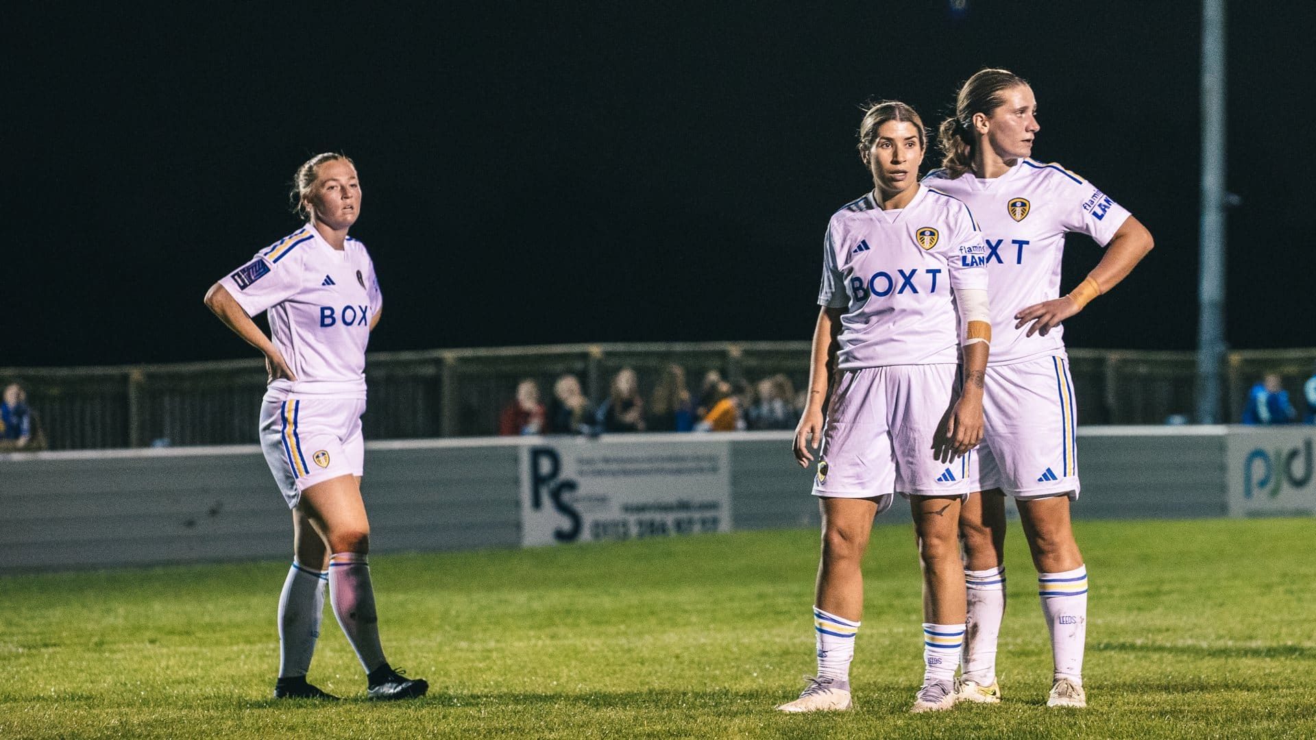 Ellie Dobson, Kathryn Smith and Katie Astle standing in a row during Leeds United Women's recent floodlit win over FCUM