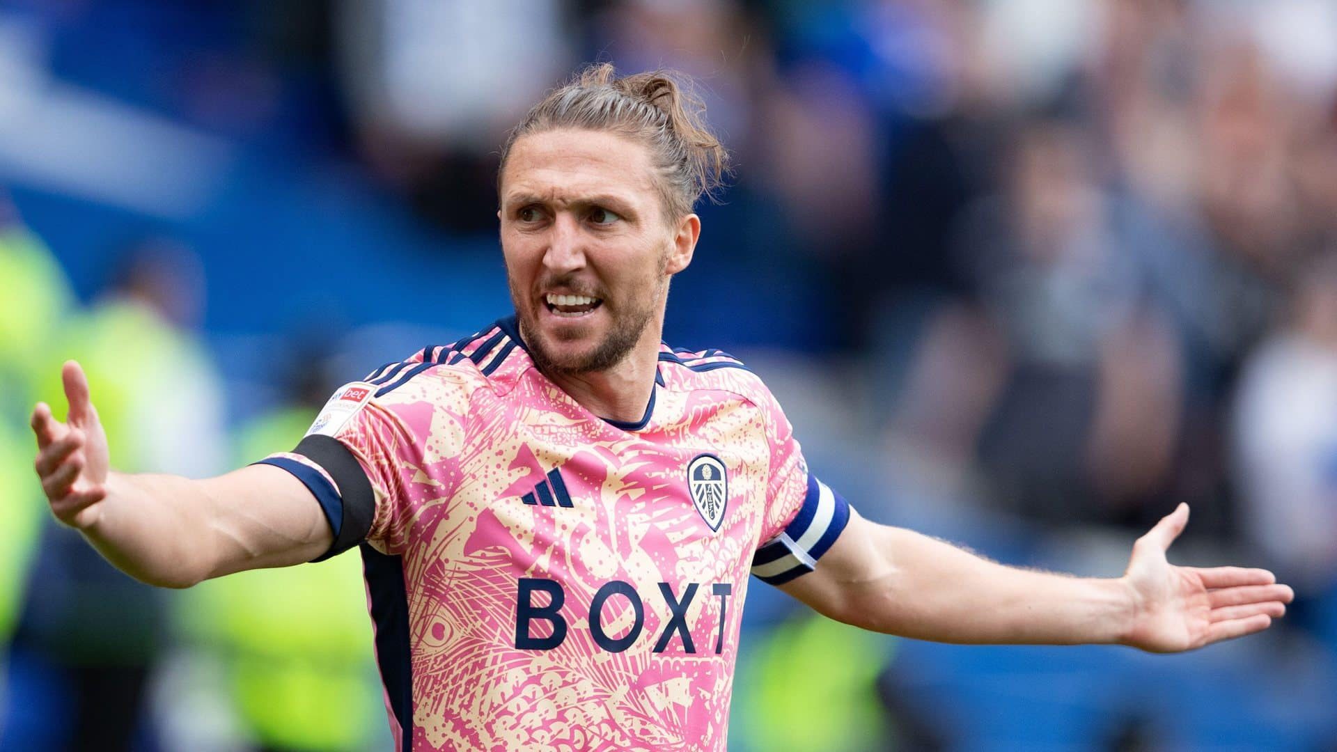 Luke Ayling at Birmingham in the new rhubarb and custard kit, with his arms spread wide in appeal, looking around and shouting at teammates who may or may not have bothered getting on the bus to the game