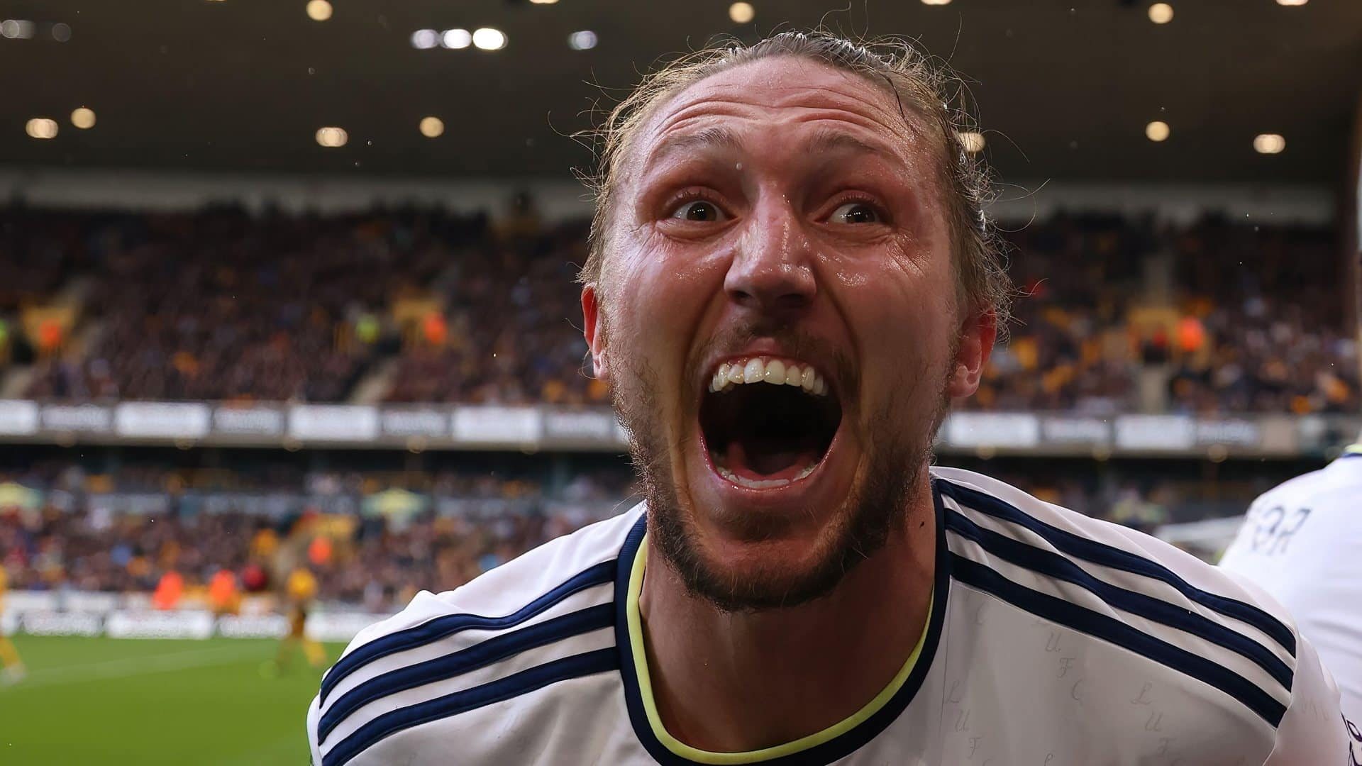 A close up of Luke Ayling's face as he celebrates Rasmus Kristensen's goal against Wolves — his eyes are almost out on stalks, he could be screaming, laughing or crying, it's probably all three at once