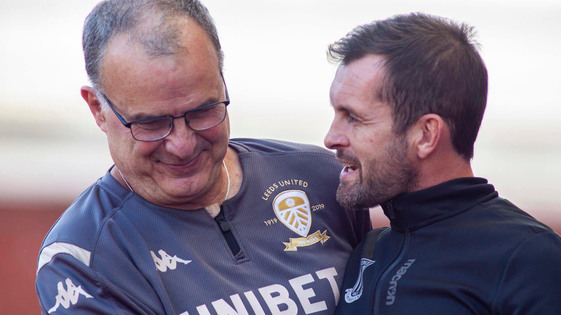 Looking cocky enough as usual, Nathan Jones is welcoming Marcelo Bielsa to Stoke before the game with Leeds in August 2019. Bielsa has the face of a man who knows his team is about to teach this weird nail-biting charlatan a football lesson