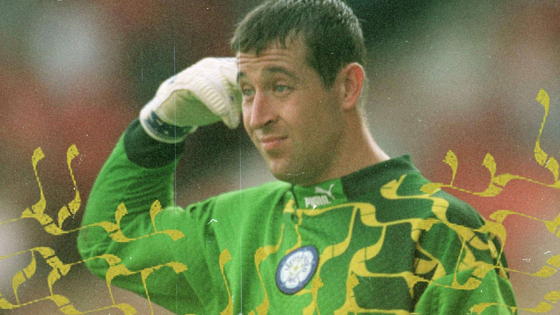 Nigel Martyn in the bright green 96/97 keeper shirt, pointing at his head