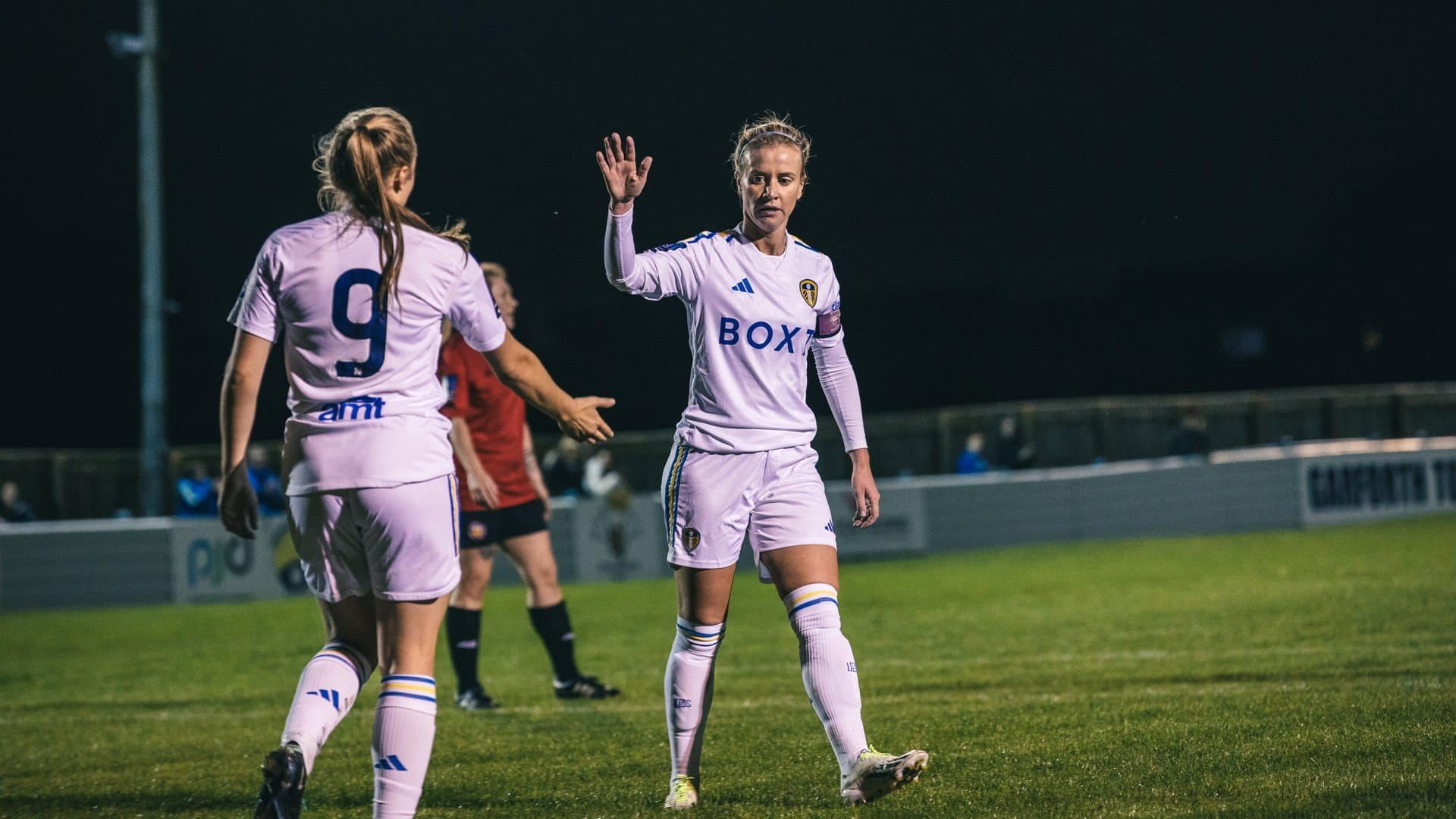 Leeds United captain Olivia Smart doing what defenders do best: high-fiving a no.9