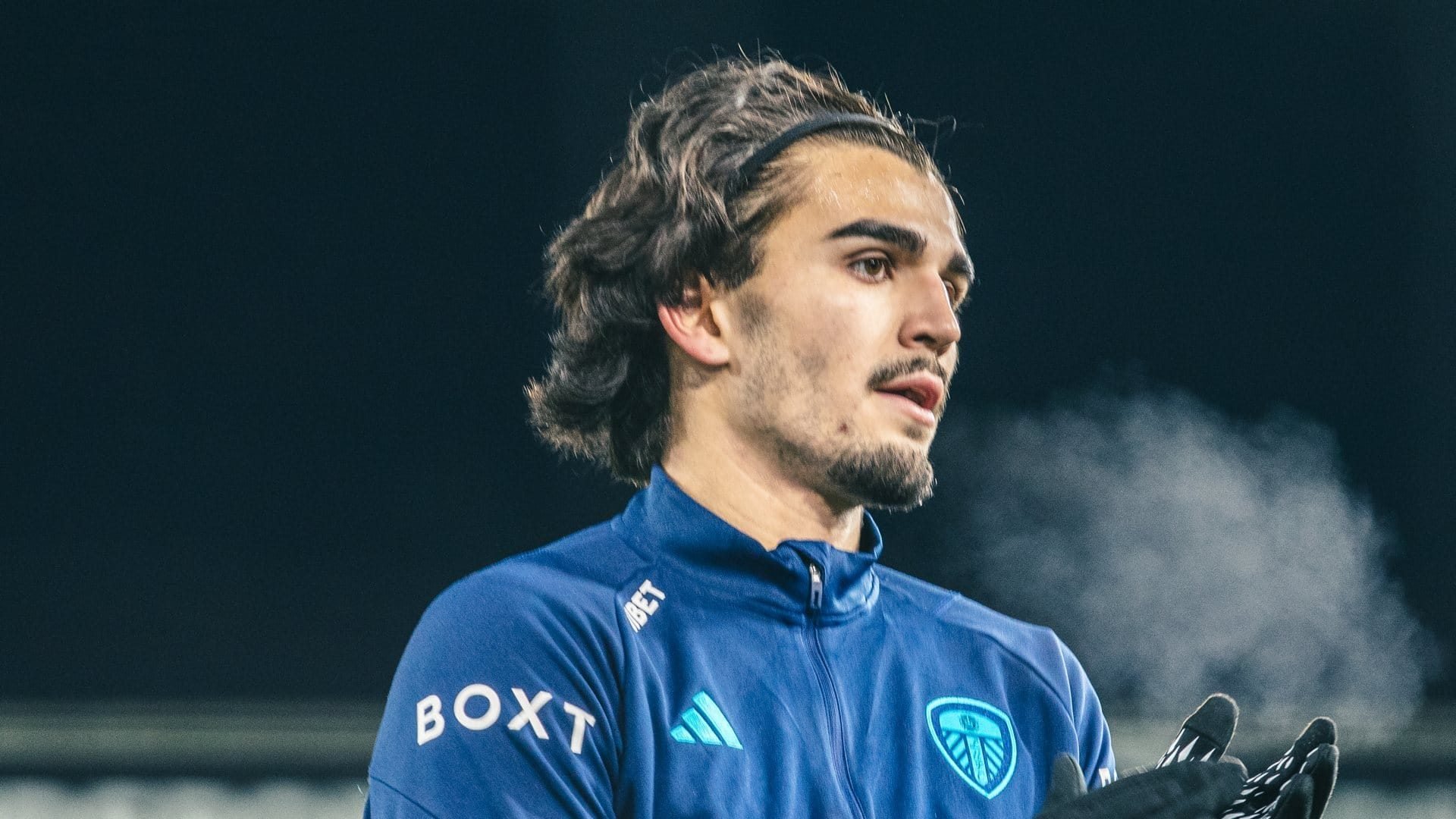 A close up of Pascal Struijk's big sexy head as his hot breath creates a cloud in the cold air during the warm up before the game with Swansea