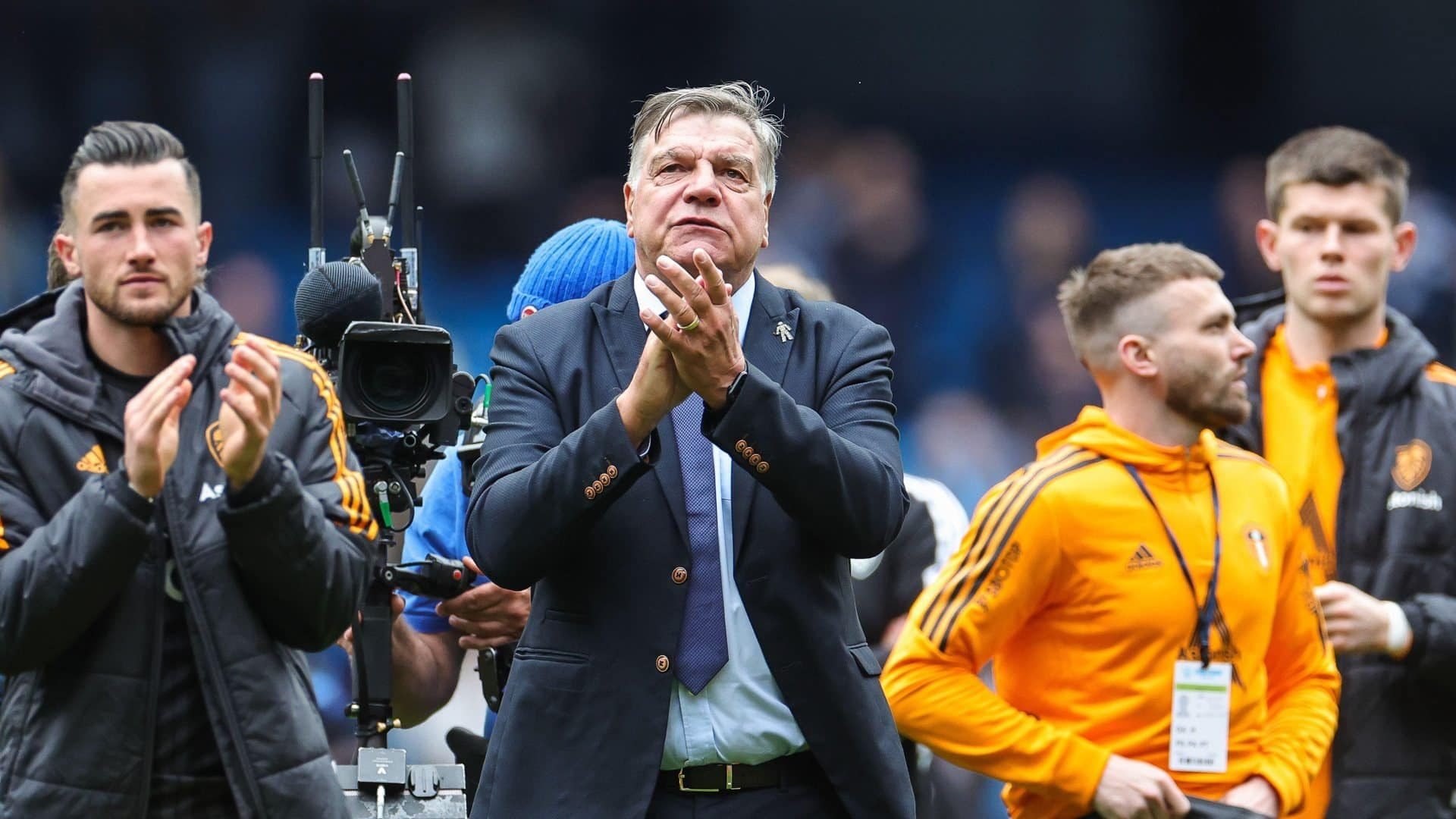 Sam Allardyce applauds the fans at the Etihad, flanked by Jackie Harrison, Stuart Dallas and Illan Meslier, three of the most worried looking footballers you'll ever see