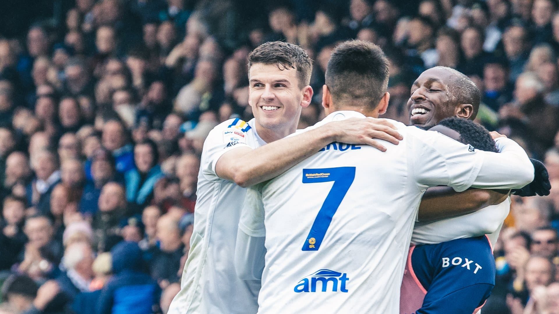 Sam Byram celebrating with Summerville, Gnonto, Piroe and Kamara against Huddersfield, looking all happy and smiling