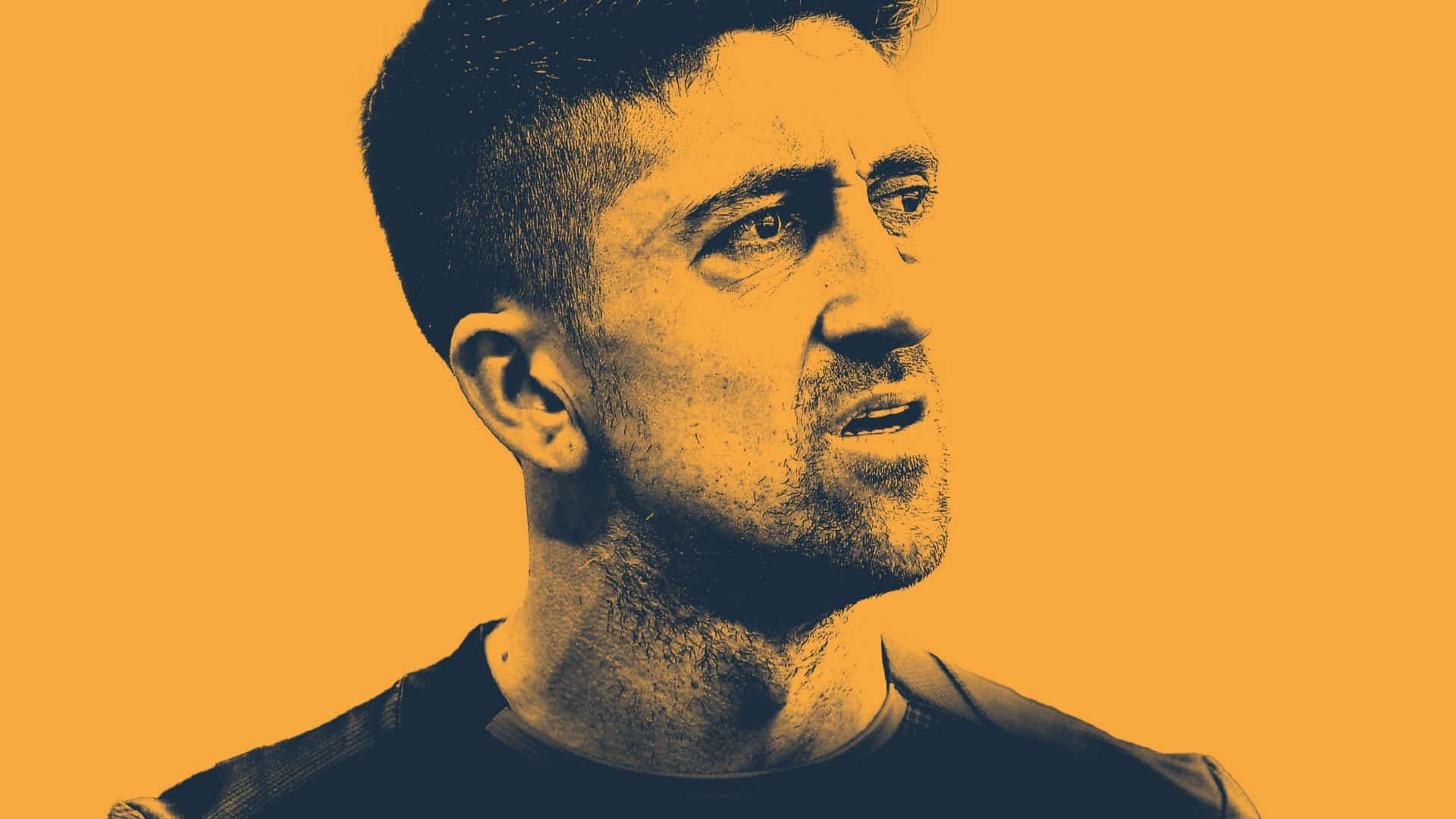 A close up of Pablo Hernandez's face, he's looking askance as usual, decoloured and set against a desert yellow background