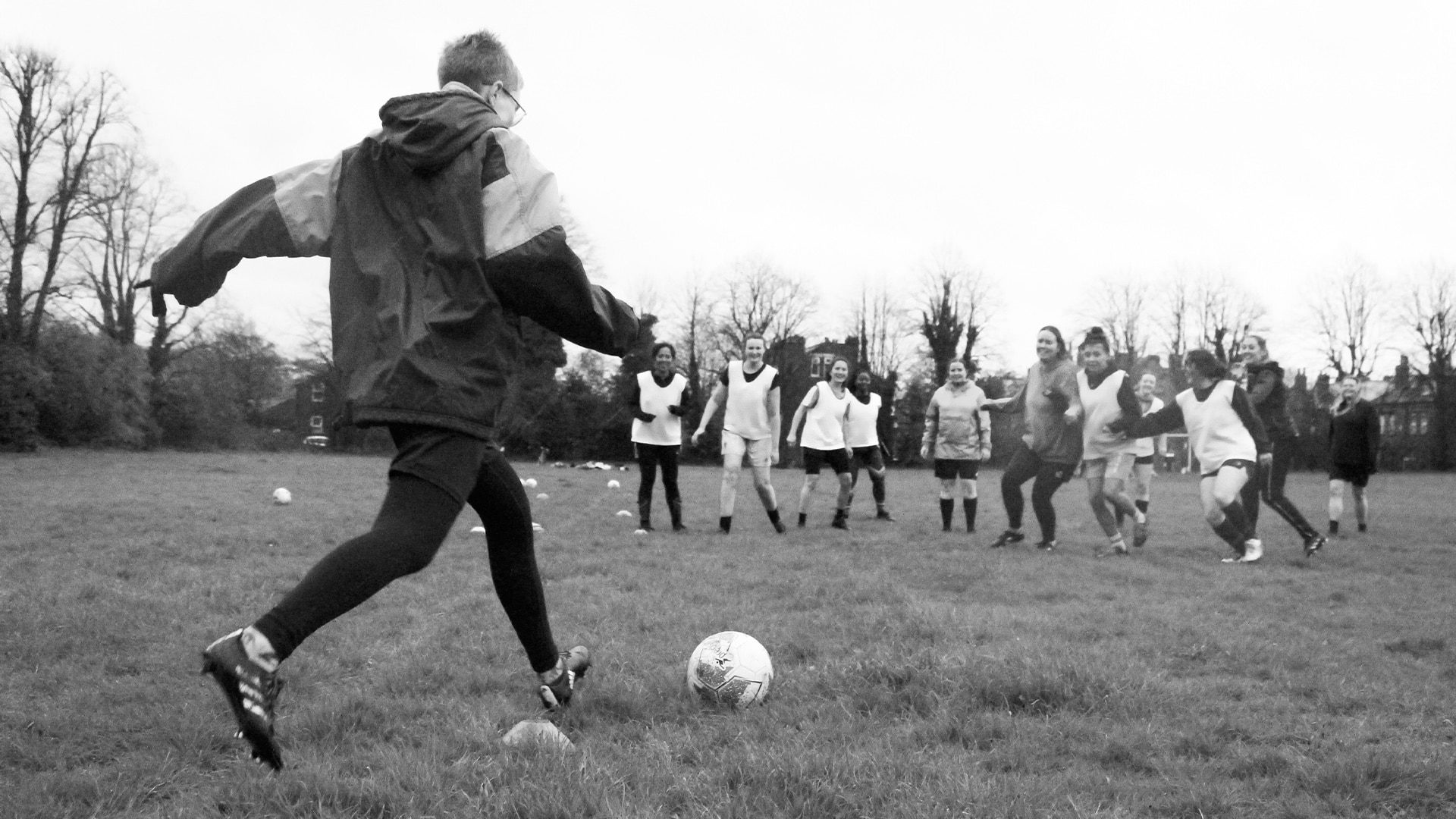 A photograph from Saf Jarvis' Man's Game of a training session between a women's football team on a recreation ground by Burley Park allotments