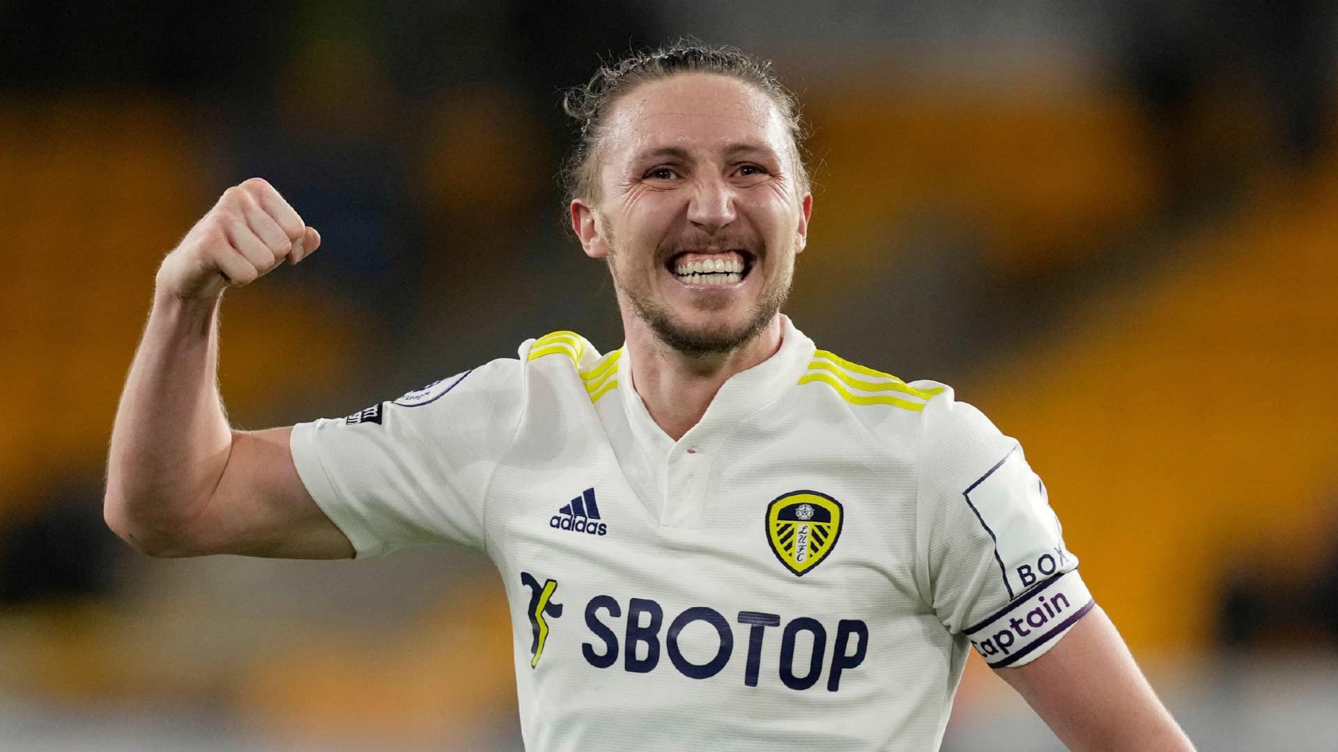 A photograph of Luke Ayling wearing the captain's armband, pumping his fist, grinning. All the good stuff