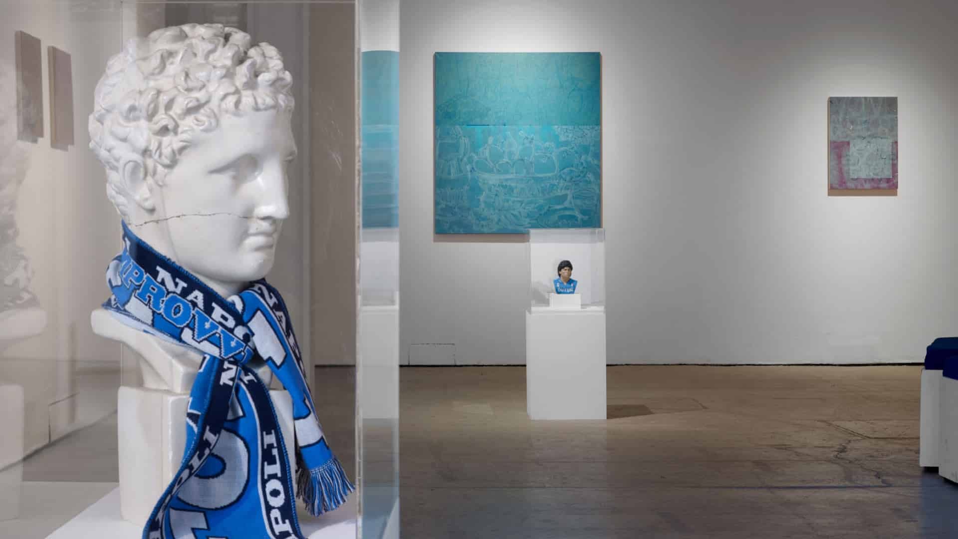 Alistair Woods' art at Castlefield Gallert featuring Napoli scarves and a bust of Diego Maradona