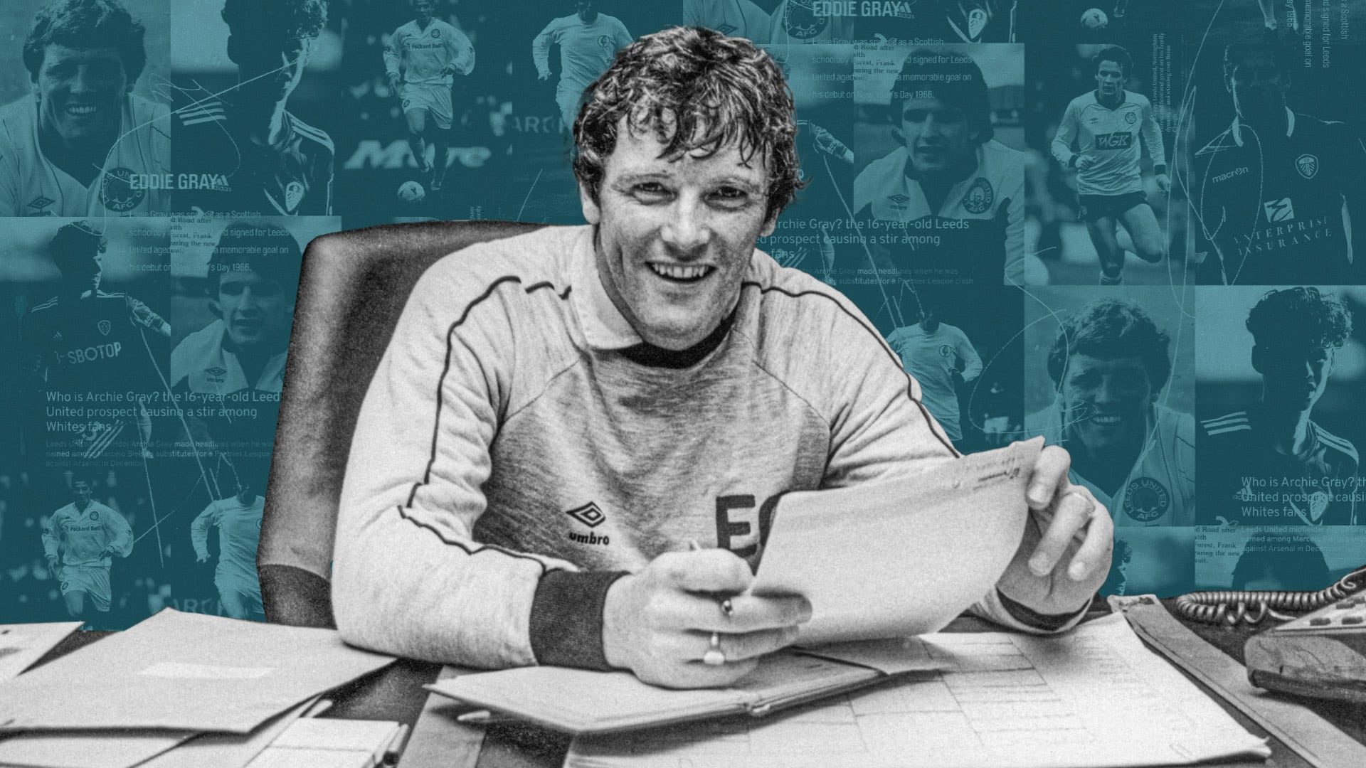 Eddie Gray sitting in his manager's office in the 80s, wearing a sweatshirt with the big initials 'EG' printed on the chest