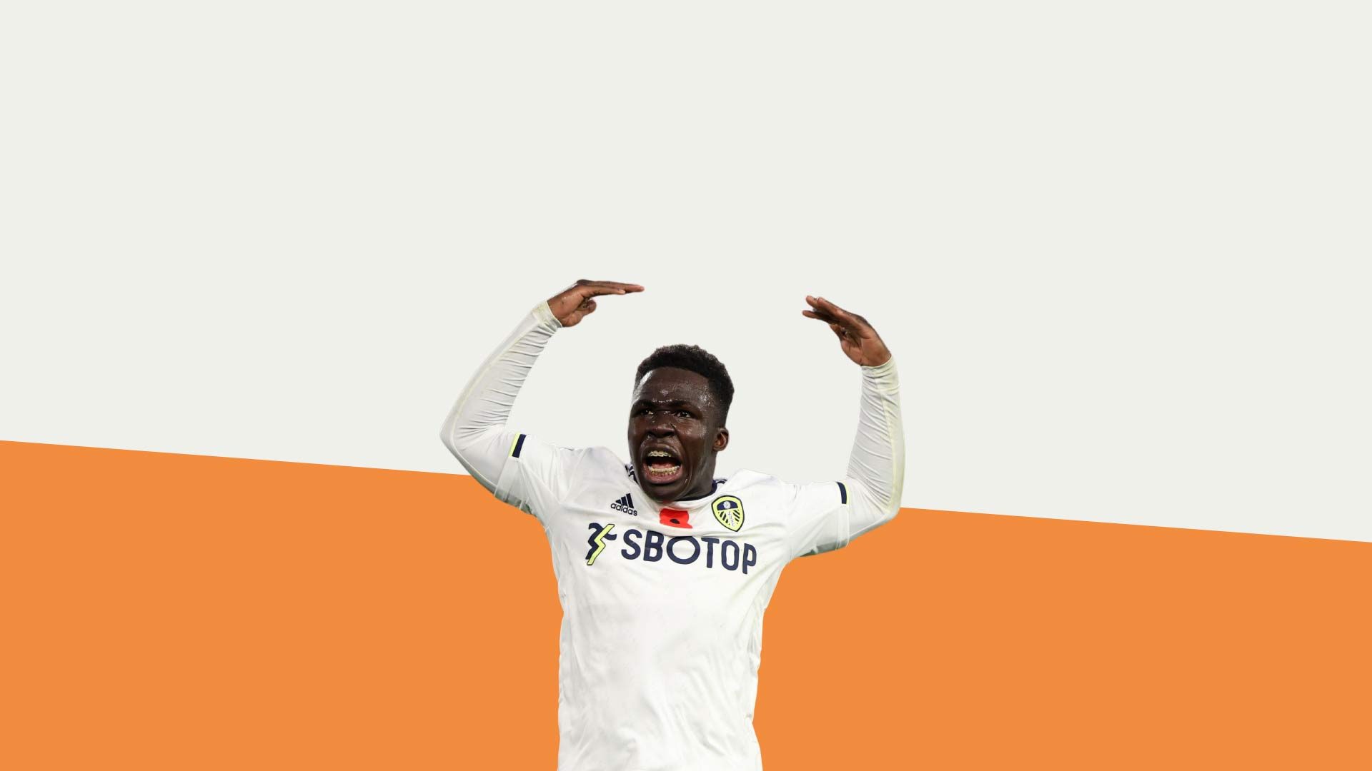 Little Willy Gnonto celebrating against a backdrop with the top half white and the bottom half third kit orange