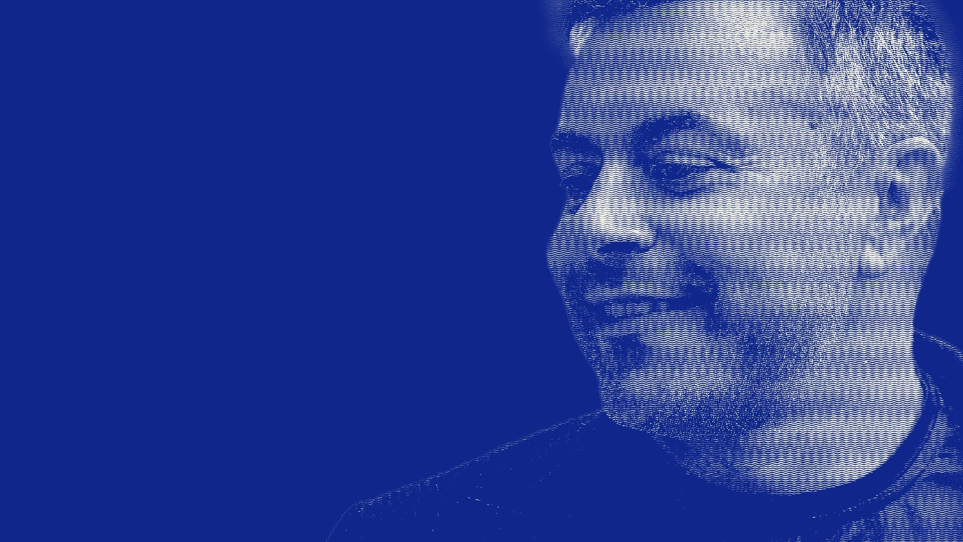 An image of Andrea Radrizzani smiling against a blue backdrop